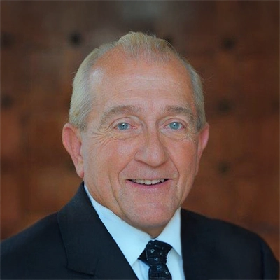 Family Medicine Practitioner Bill Redmond Smiling In Suit