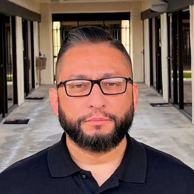 Billing Lead Jesse Bojorquez In Collared Shirt Looking Stern