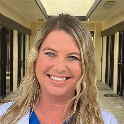 Registered Nurse Lindsay Sherfield Smiling In Lab Coat