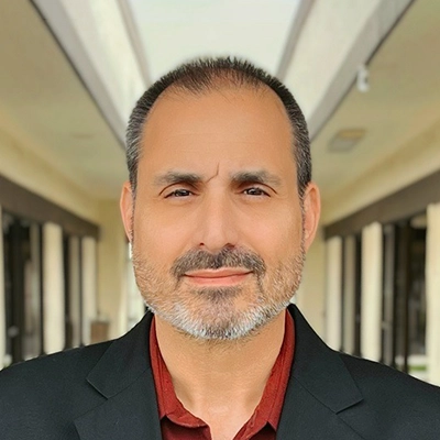 Marketing & Promotions Director Mike Giusti Smiling In Suit